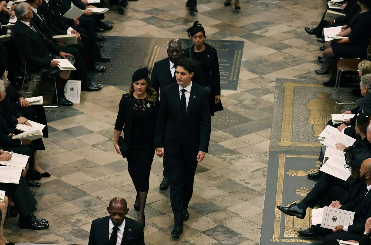 Prime Minister Justin Trudeau and his wife Sophie Gregoire Trudeau arrive at Westminster Abbey ahead of the State Funeral of Britain’s Queen Elizabeth II, in London, Monday Sept. 19, 2022. THE CANADIAN PRESS/AP-Jack Hill/Pool Photo via AP