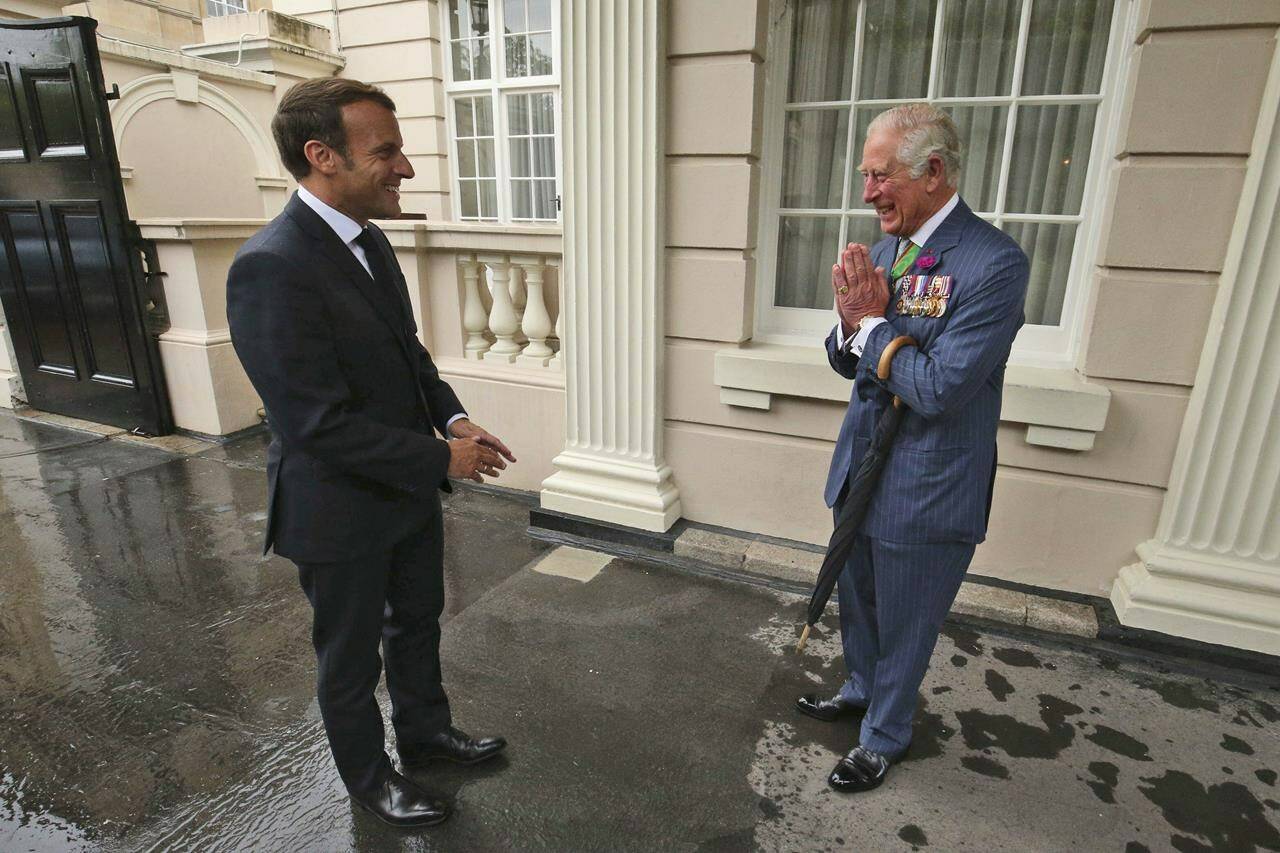 FILE - Britain’s Prince Charles welcomes French president Emmanuel Macron, left, to Clarence House in London, Thursday June 18, 2020. French President Emmanuel Macron’s office on Friday, March 24, 2023, said a state visit by Britain’s King Charles III has been postponed amid mass strikes and protests in France. The king had been scheduled to arrive in France on Sunday on his first state visit as monarch, before heading to Germany on Wednesday. (Jonathan Brady/Pool via AP, File)