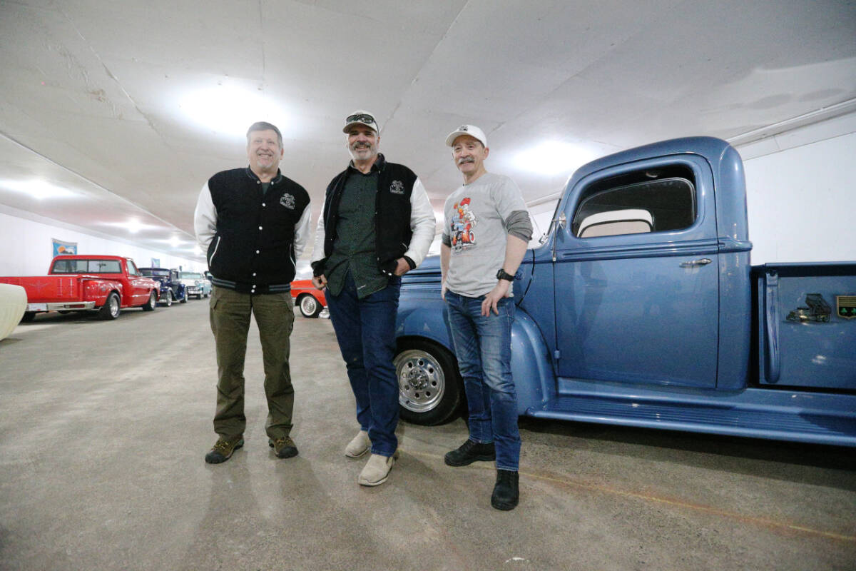 Torque Masters Car Club vice-president Curtis Smith, president Ken Coward, and vice-president Jim Clayton stand inside their clubhouse March 28. The club’s latest community effort is fundraising to buy at least one reliable used car for the Ukrainian Safe Haven in East Sooke. (Justin Samanski-Langille/News Staff)