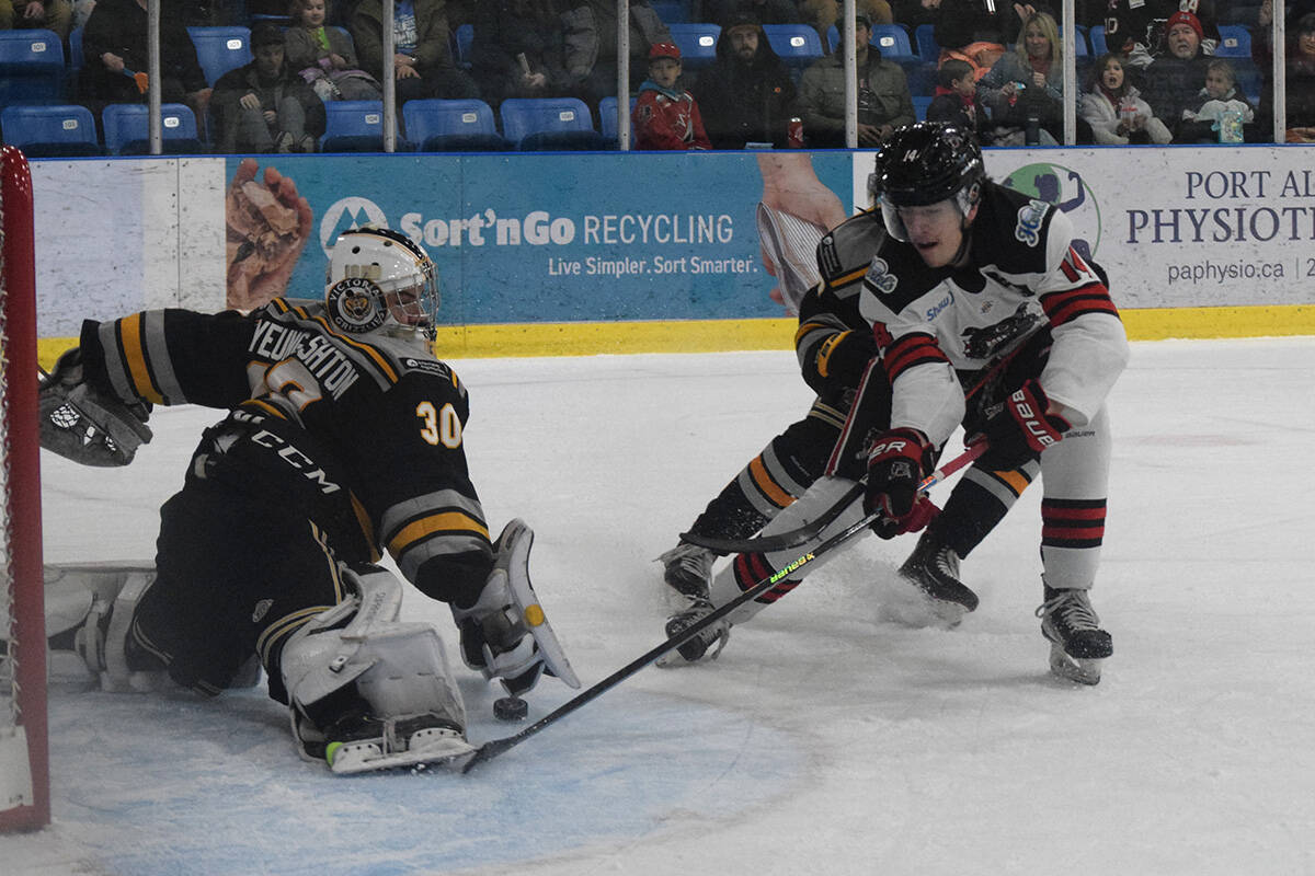 Victoria Grizzlies goaltender Oliver Auyeung-Ashton makes a save on Alberni Valley Bulldogs forward Dakota MacIntosh during Game 2 of the BCHL playoffs on April 1, 2023. (ELENA RARDON / Alberni Valley News)