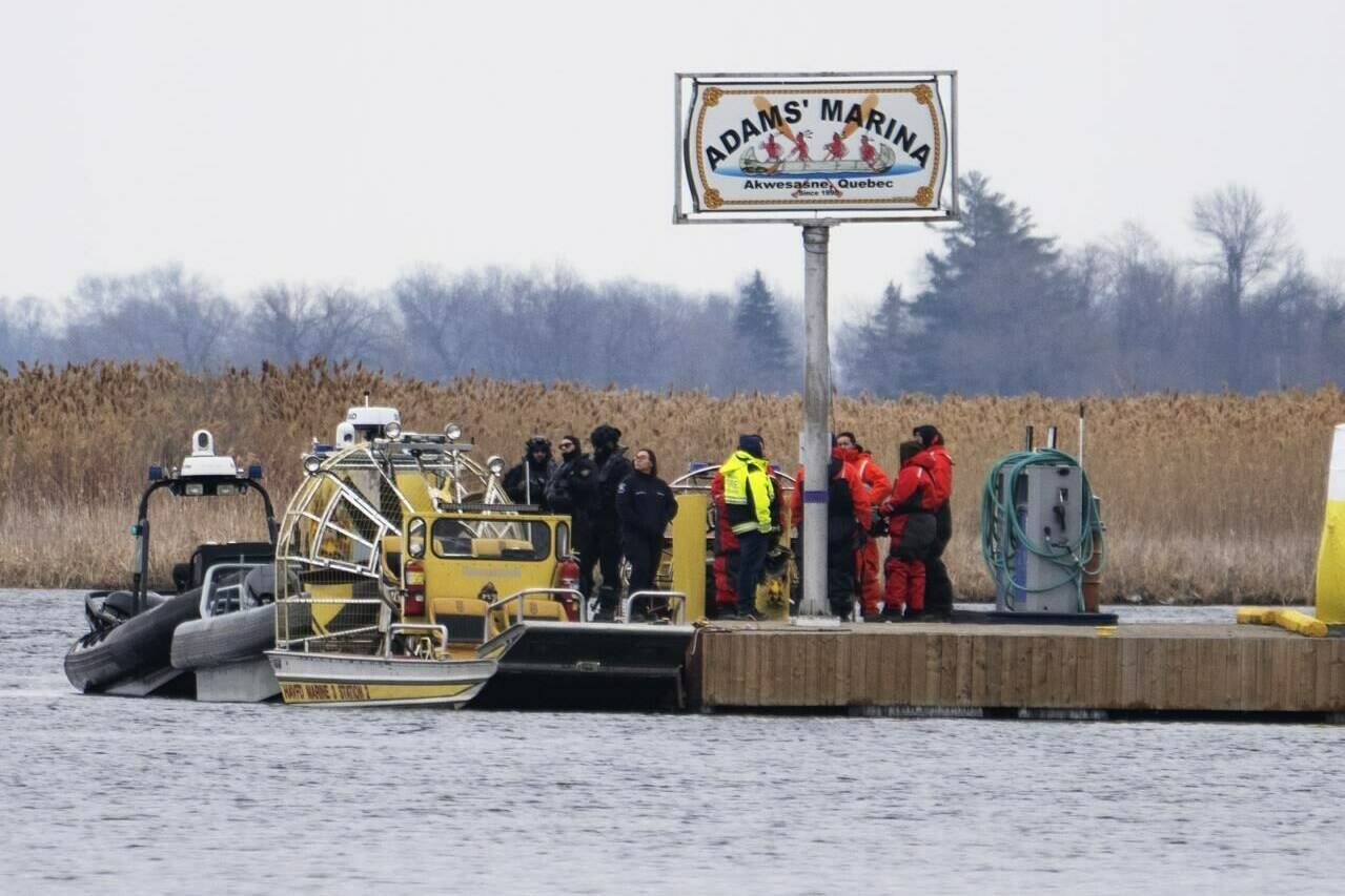 Searchers dock at a marina in Akwesasne, Que. Friday, March 31, 2023. The search continues for a man missing from the Mohawk community of Akwesasne in an area of the St. Lawrence River where the bodies of eight migrants were recovered earlier this week. THE CANADIAN PRESS/Ryan Remiorz