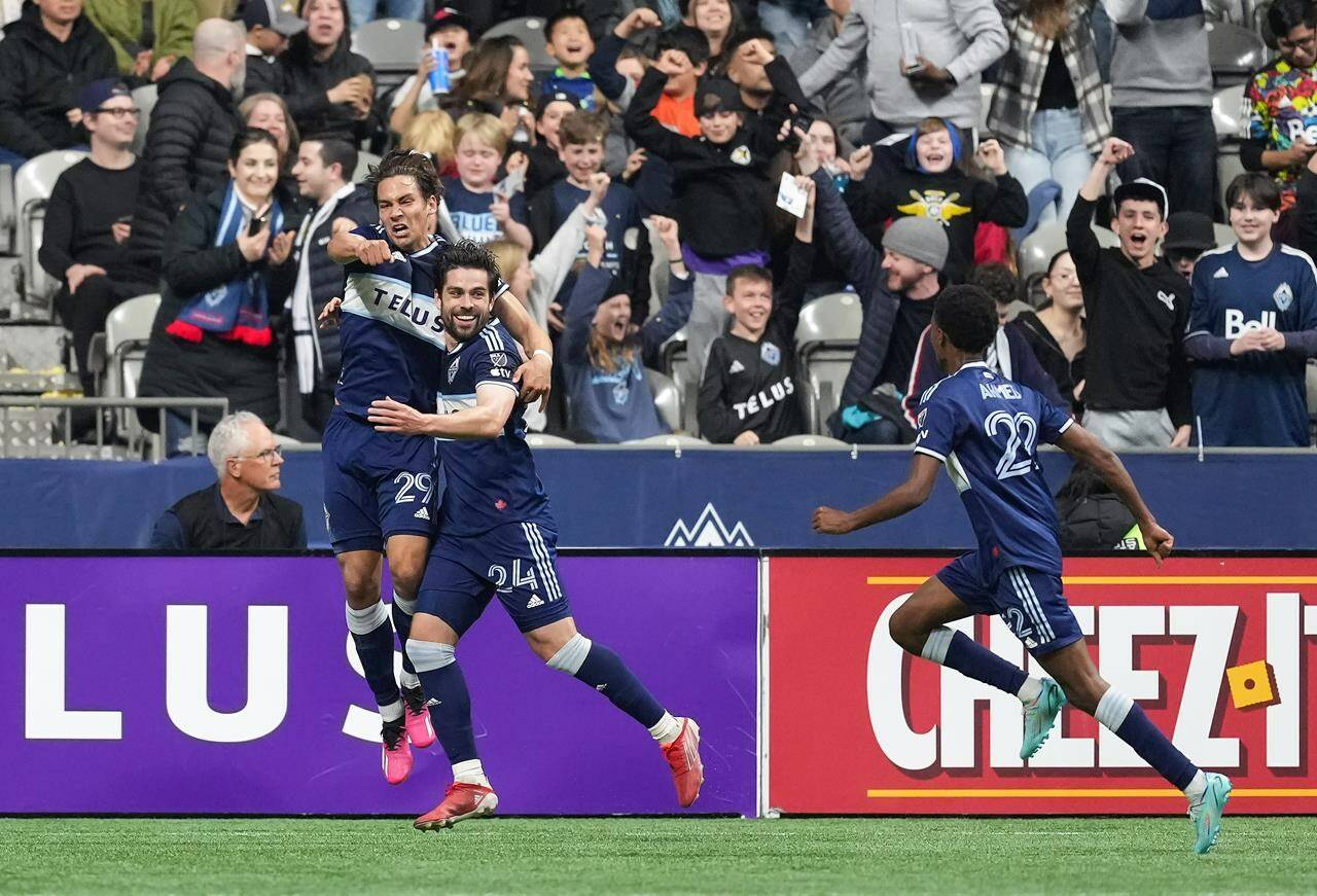 Vancouver Whitecaps’ Simon Becher, from left to right, Brian White and Ali Ahmed celebrate White’s goal against CF Montreal during the first half of an MLS soccer game in Vancouver, on Saturday, April 1, 2023. Becher has been named the Major League Soccer player of the matchday. THE CANADIAN PRESS/Darryl Dyck