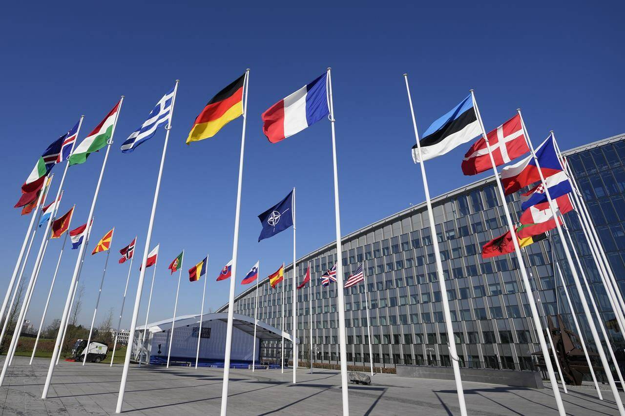 An empty flagpole stands between the national flags of France and Estonia outside NATO headquarters in Brussels, Monday, April 3, 2023. Finland awaits an official green light to become the 31st member of the world’s biggest security alliance as NATO foreign ministers prepare to meet in Brussels on Tuesday and Wednesday. (AP Photo/Virginia Mayo)