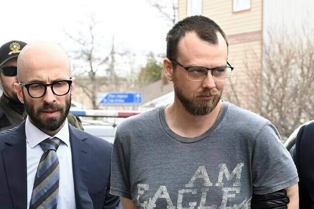 Steeve Gagnon, right is escorted by police into court in Amqui, Que., Tuesday, March 14, 2023.The Quebec man c,harged after a pickup truck crashed into pedestrians last month is now facing three counts of first-degree murder. THE CANADIAN PRESS/Jacques Boissinot