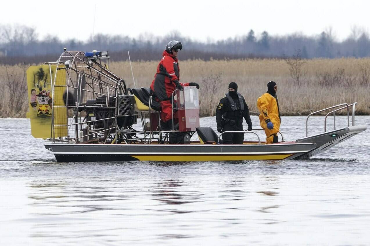 Searchers look for victims Friday, March 31, 2023, after a boat capsized and left eight people dead in Akwesasne, Que. Authorities investigating the disappearance of an Akwesasne man whose boat was found near the bodies of eight migrants pulled from the St. Lawrence River say he was connected to the case. THE CANADIAN PRESS/Ryan Remiorz