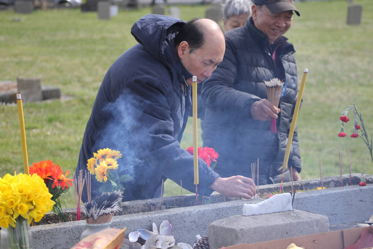 Members of Victoria’s Chinese diaspora community lay flowers and light incense in celebration of Qingming at the Chinese Cemetery at Harling Point in Oak Bay April 5. (Austin Westphal/News Staff)
