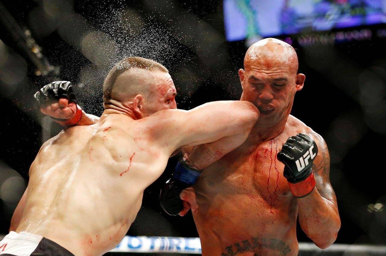Rory MacDonald, left, and Robbie Lawler exchange blows in their welterweight title mixed martial arts bout at UFC 189 in Las Vegas, Saturday, July 11, 2015. MacDonald is now headed to the UFC Hall of Fame. THE CANADIAN PRESS/AP-John Locher