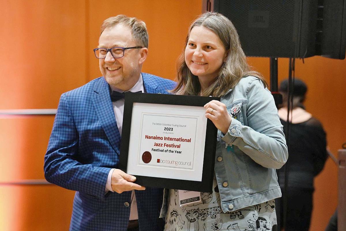 Dirk Heydemann, the Nanaimo International Jazz Festival Association artistic director, accepts B.C. Touring Council’s inaugural Festival of the Year award from Julie Fowler, a founding member of BC Music Festival Collective, during Pacific Contact 2023 in New Westminster on Saturday, April 15. (Photo by Tom Landa)