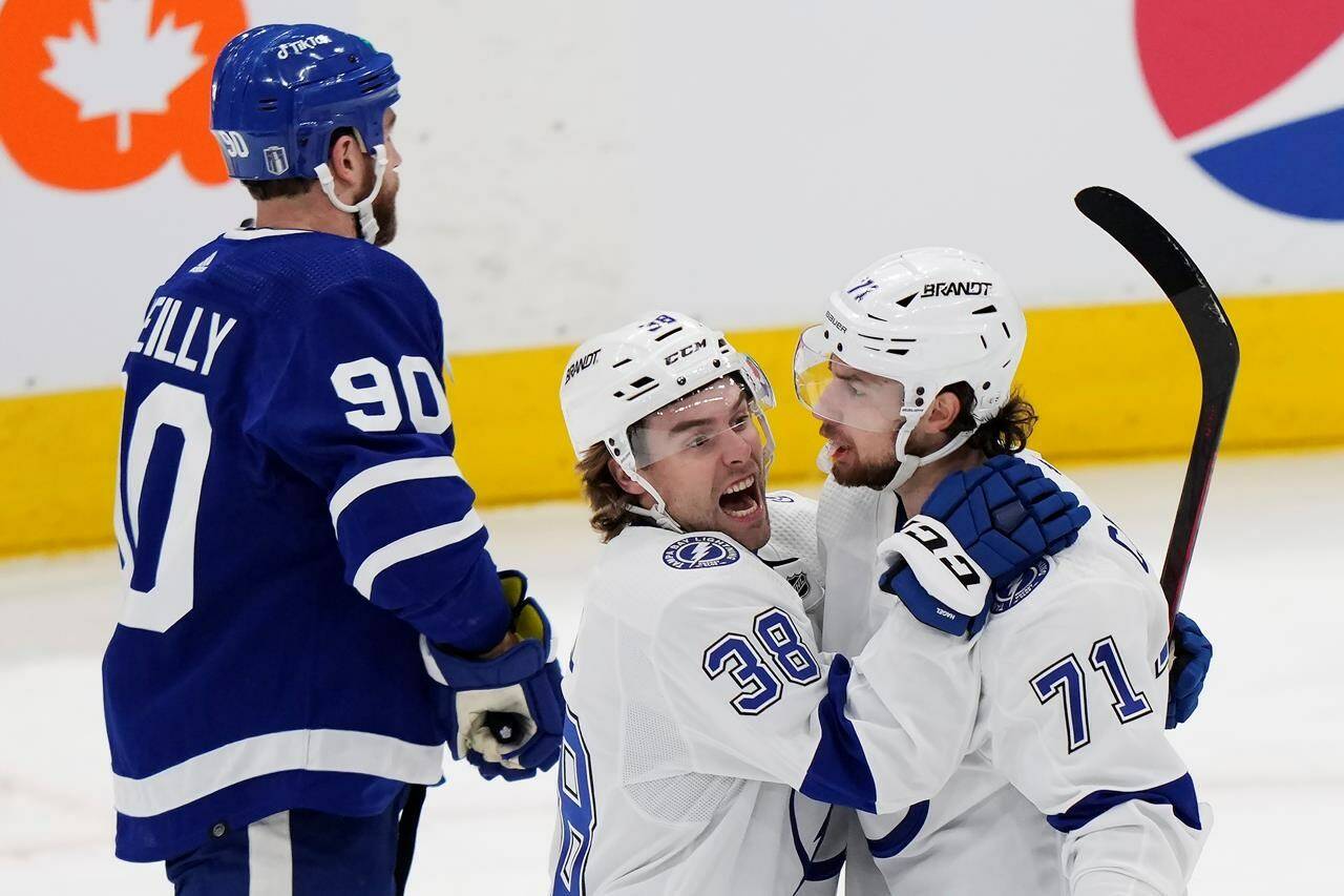 Tampa Bay Lightning forward Anthony Cirelli (71) celebrates his goal with left wing Brandon Hagel (38) as Toronto Maple Leafs forward Ryan O’Reilly (90) skates past during first period NHL Stanley Cup playoff hockey action in Toronto, on Tuesday, April 18, 2023. O’Reilly stepped in front of the cameras and microphones to face the music following a disastrous playoff opener. THE CANADIAN PRESS/Frank Gunn