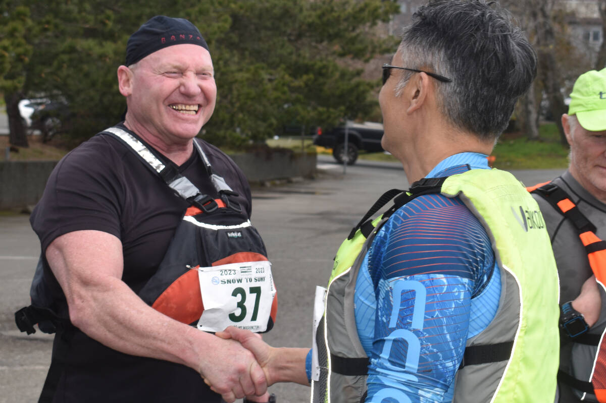 Great rivals, better friends. Bill Brett (left) of Banzai congratulates Rupert Wong on Tsunami’s victory. Photo by Terry Farrell