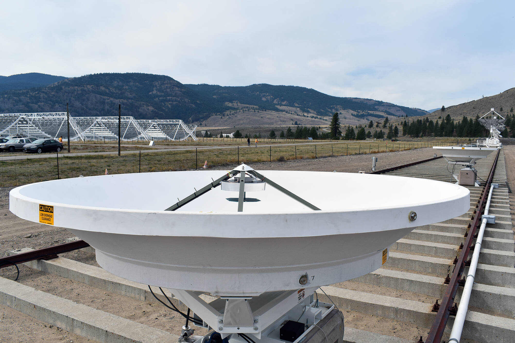 The two CHORD telescopes are tiny compared to the larger Synthesis Telescopes (right) and CHIME (left) radio telescopes they will eventually assist and replace at the Dominion Radio Astrophysical Observatory. 512 of the new telescopes will be built at the facility in Kaleden to help better probe the secrets of the universe. (Brennan Phillips - Western News)