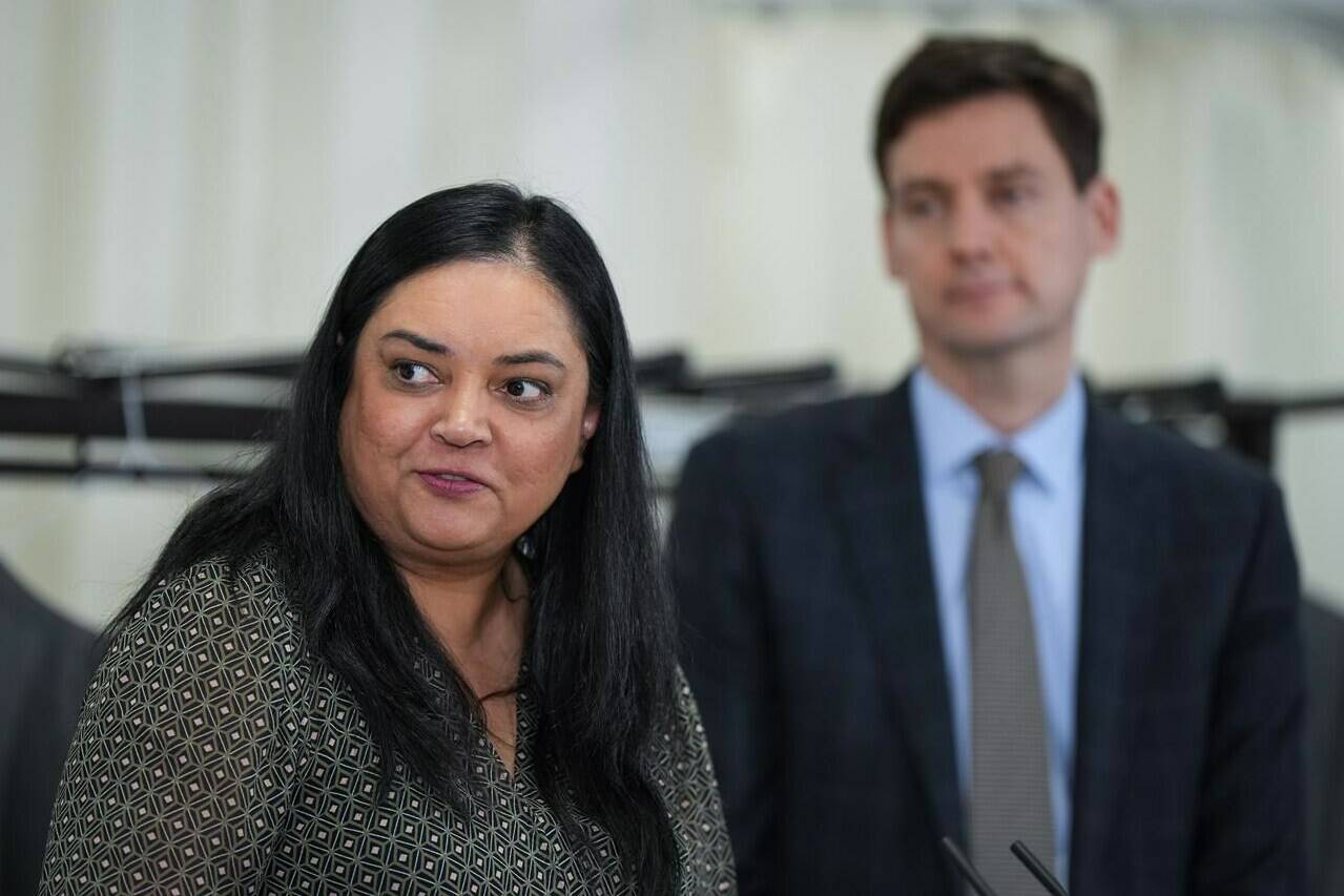 B.C. Nurses’ Union President Aman Grewal speaks as B.C. Premier David Eby, back right, listens during an announcement at Langara College in Vancouver, on January 9, 2023. THE CANADIAN PRESS/Darryl Dyck