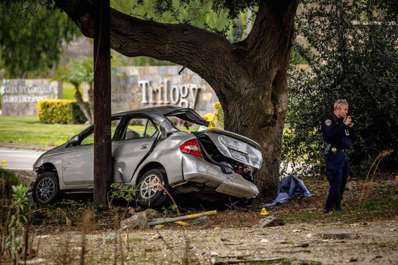 FILE - An officer with the California Highway Patrol’s (CHP) Multidisciplinary Accident Investigation Team (MAIT) investigates the scene of a deadly crash in the Temescal Valley, south of Corona, Calif., Monday, Jan. 20, 2020. A jury found a Southern California man guilty Friday, April 28, 2023, in the killings of three teenage boys after they played a doorbell-ringing prank on him in 2020. (Watchara Phomicinda/The Orange County Register via AP, File)