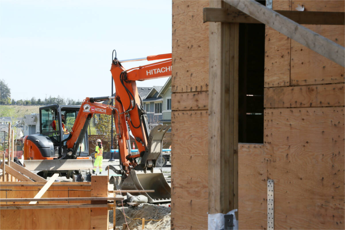 Crews work outside a multi-unit build in the Royal Bay development in Colwood. (Katherine Engqvist/News Staff)