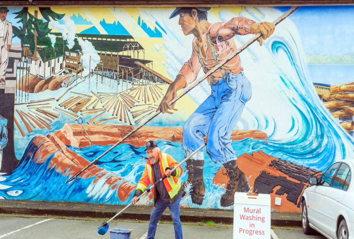 Spring cleaning in Chemainus means mural washing, a job Wayne Gilmore’s been doing since 2001. (Photo by Art Carlyle)