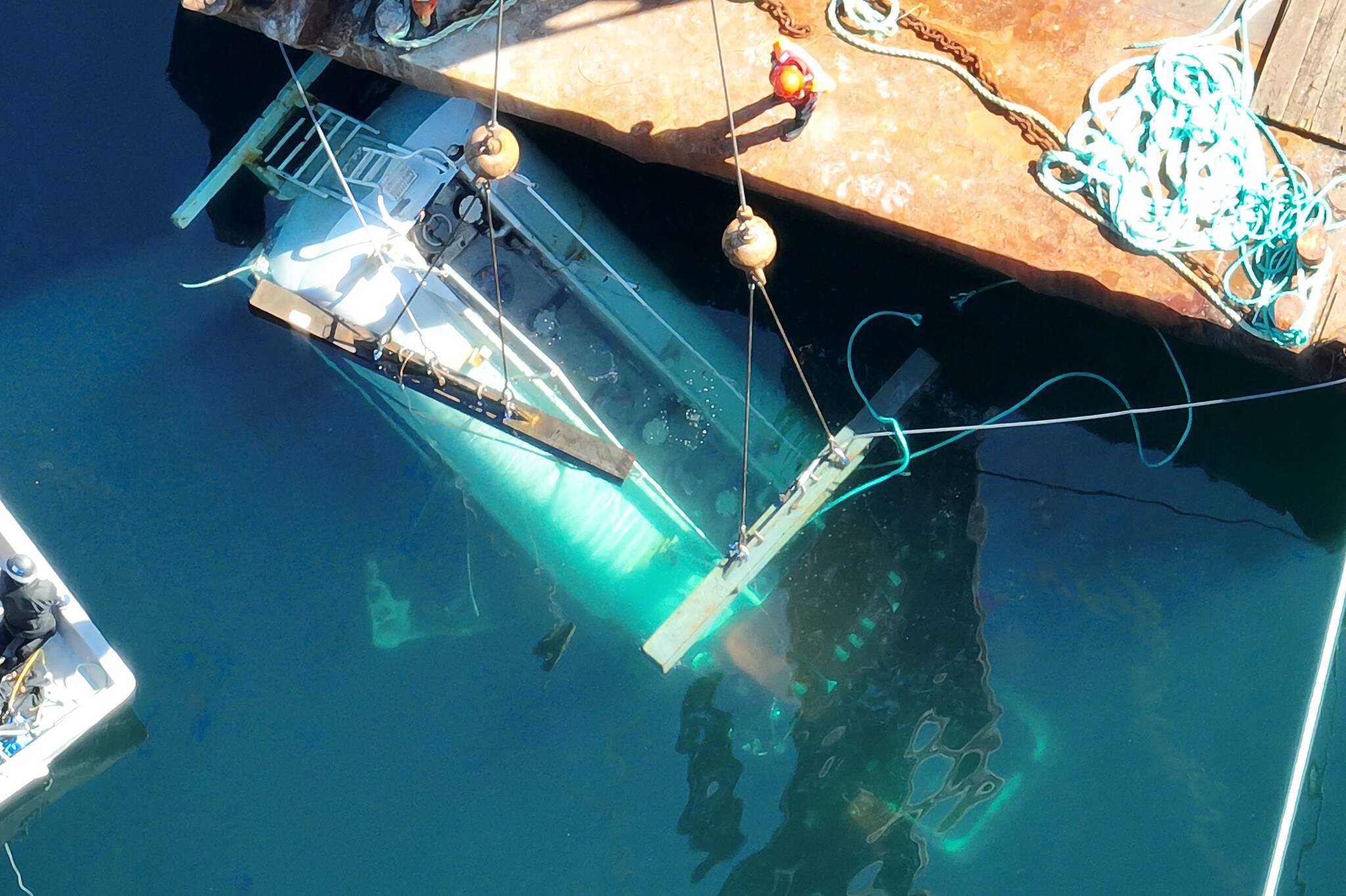Crews work to raise the diesel truck from Chancellor Channel. Photo courtesy DFO Marine Mammal Response Unit