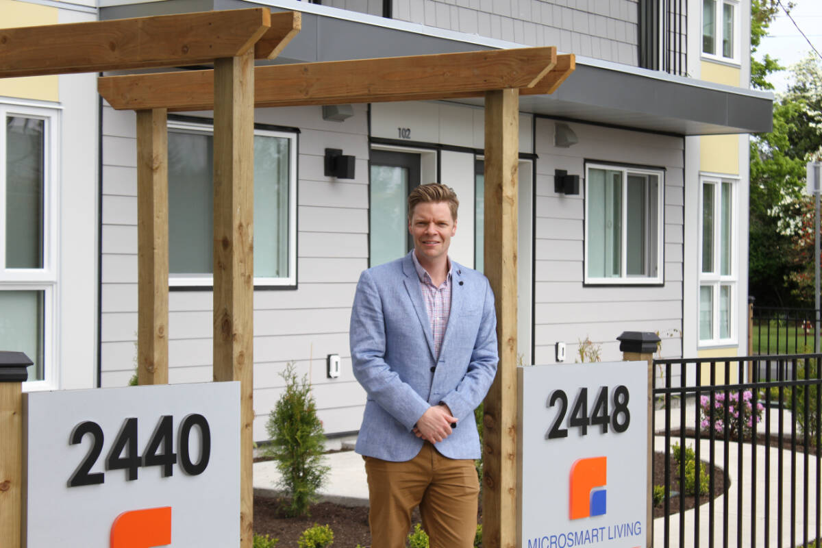 Saanich Mayor Dean Murdock outside two 11-unit purpose-built rental buildings on Richmond Road near Royal Jubilee Hospital. (Austin Westphal/News Staff)