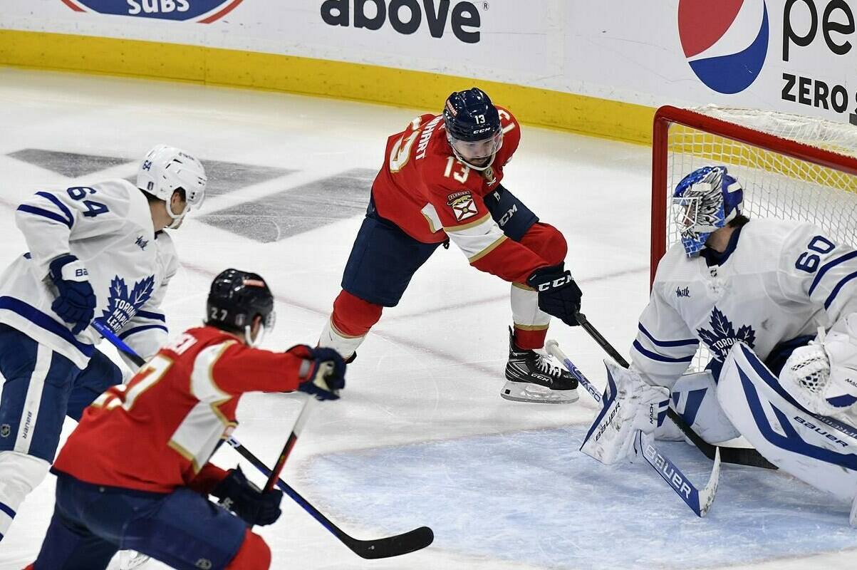 Florida Panthers center Sam Reinhart (13) scores the game-wining goal against Toronto Maple Leafs goaltender Joseph Woll (60) during overtime of Game 3 of an NHL hockey Stanley Cup second-round playoff series, Sunday, May 7, 2023, in Sunrise, Fla. (AP Photo/Michael Laughlin)
