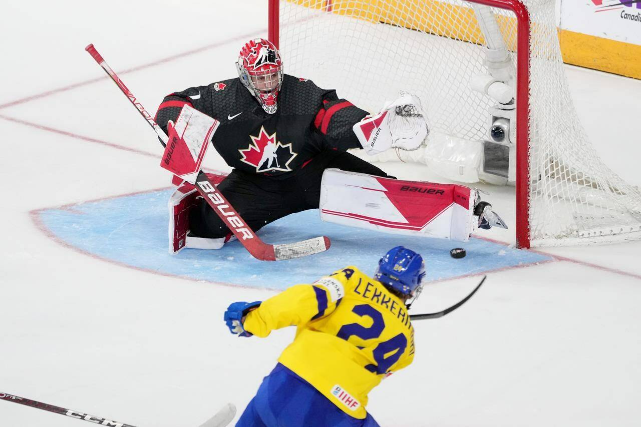 Canada’s goaltender Thomas Milic, left, stretches to make a pad save on Sweden’s Jonathan Lekkerimaki during second period IIHF World Junior Hockey Championship action in Halifax, Saturday, Dec. 31, 2022. The Vancouver Canucks’ top draft pick from 2022 says he’s looking to develop and put last season’s illness and injury struggles behind him. THE CANADIAN PRESS/Darren Calabrese