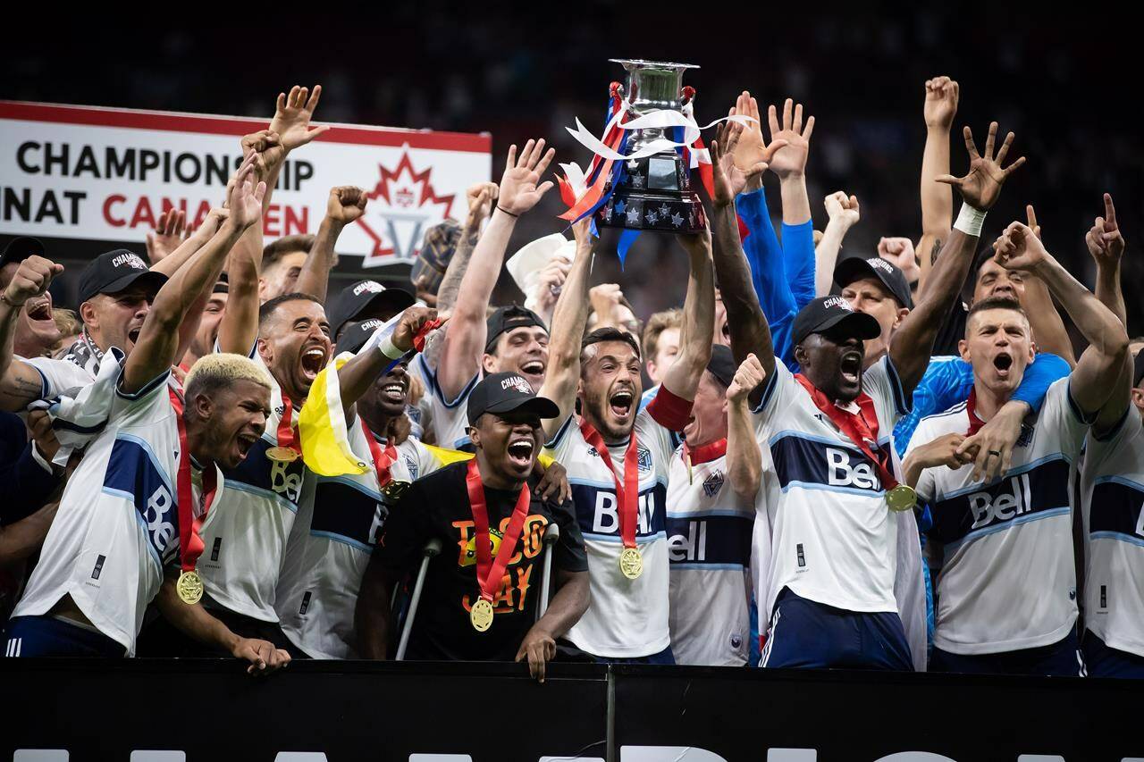 Vancouver Whitecaps’ Russell Teibert, centre, hoists the Voyageurs Cup after Vancouver defeated Toronto FC in penalty kicks during the Canadian Championship soccer final, in Vancouver, on Tuesday, July 26, 2022. The message from the Vancouver Whitecaps is clear: success in the Canadian Championship is crucial to the club and its fans this season.THE CANADIAN PRESS/Darryl Dyck