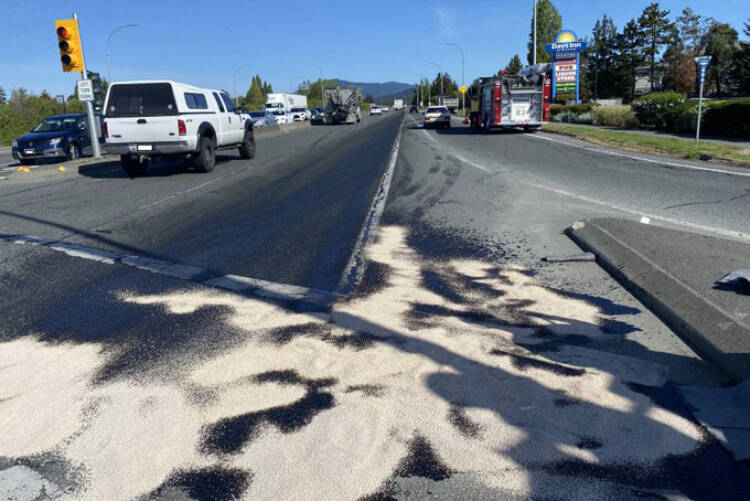 Emergency crews tend to a fuel spill on the Pat Bay Highway at Beacon Avenue in Sidney on May 11. (Sidney Fire/Twitter)