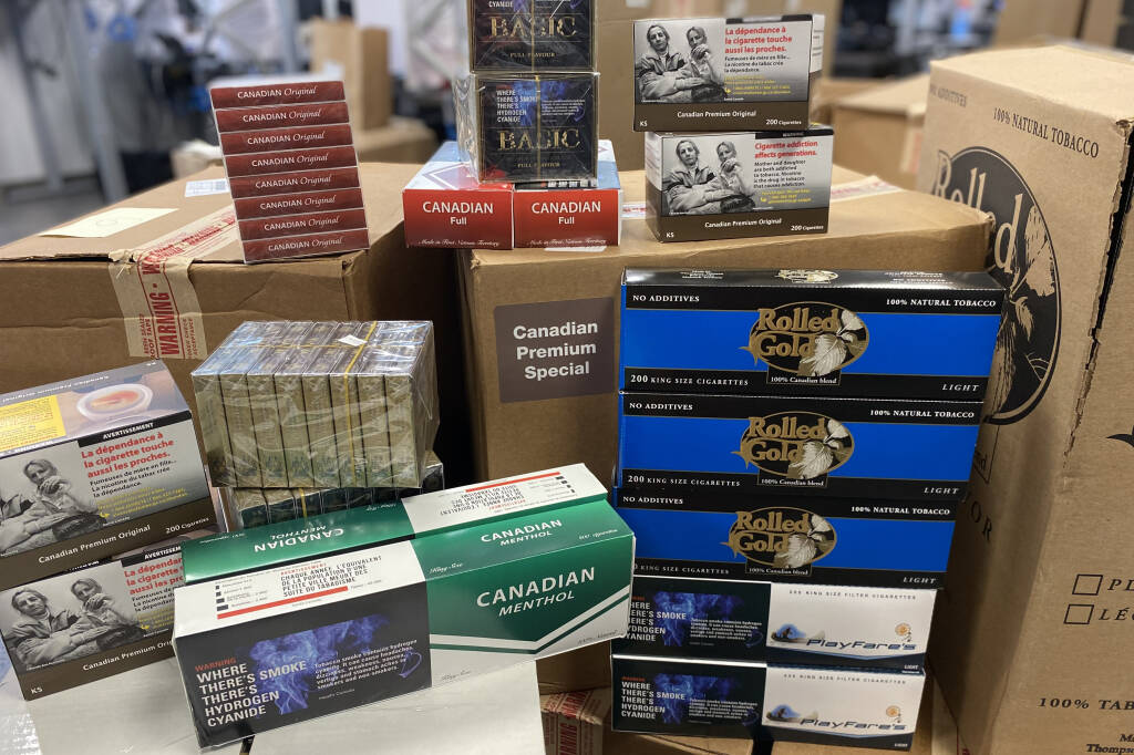 Victoria police seized more than 2,000 cartons of contraband cigarettes and $65,000 in cash after executing two search warrants. (Courtesy Victoria Police Department)