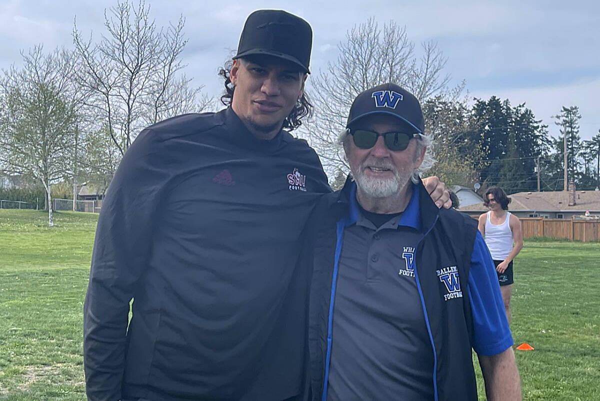 Former Ballenas Whalers player Sebastian Howard, who was recently drafted by the Calgary Stampeders, visiting friends and coaches that include Dan Smith, right. (Michael Briones photo)