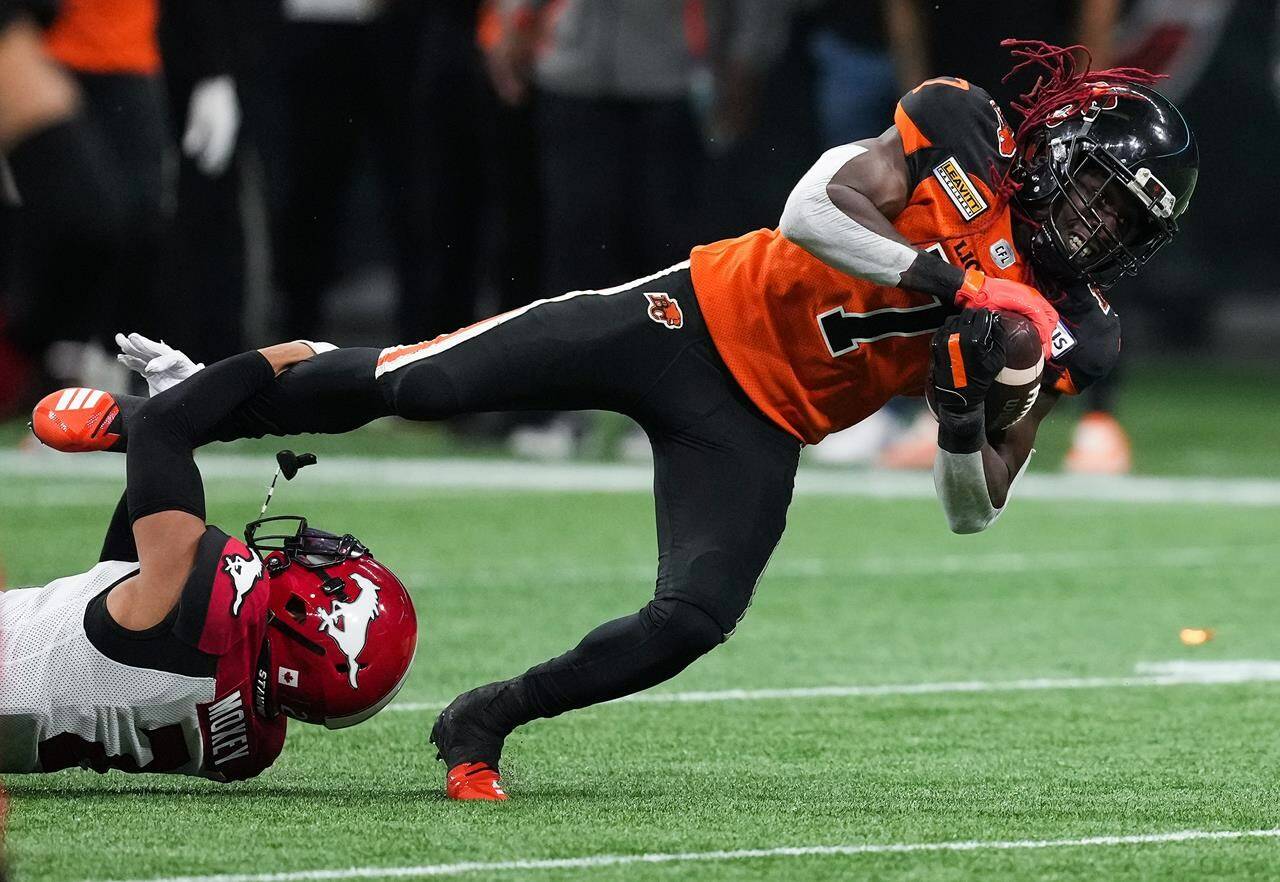 B.C. Lions’ Lucky Whitehead, right, is tackled by Calgary Stampeders’ Jonathan Moxey during the second half of CFL football game in Vancouver, on Saturday, September 24, 2022. THE CANADIAN PRESS/Darryl Dyck