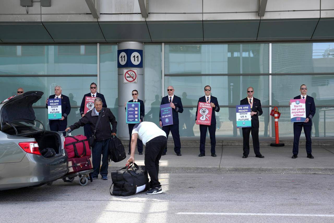 WestJet Airlines pilots stand on a picket line at Toronto’s Pearson Airport on Monday May 8, 2023. WestJet CEO Alexis von Hoensbroech says a massive gap remains between the airline’s offer to pilots and the union’s counterproposal for a new contract as job action looms. THE CANADIAN PRESS/Chris Young