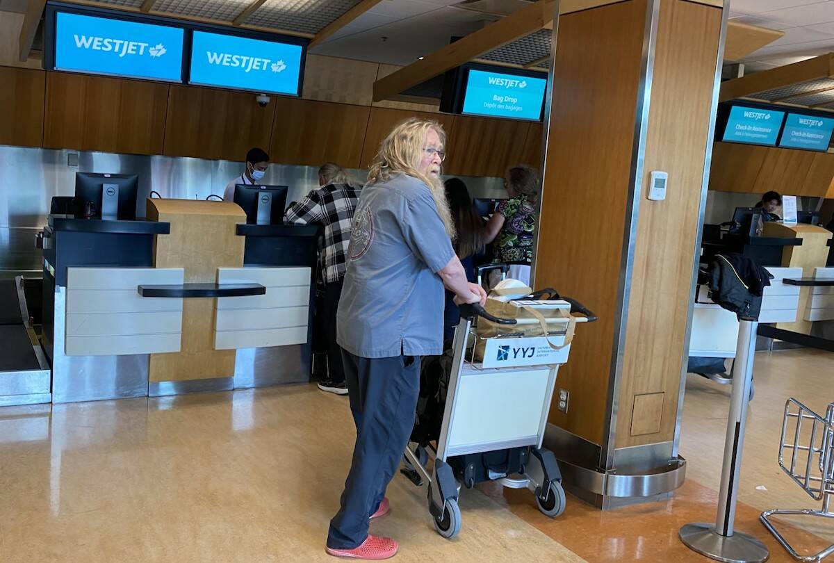 Brian Kennedy waits in line to drop off his luggage at the Victoria International Airport. Kennedy said he’s been on the edge of his seat as a possible WestJet strike looms. (Brendan Mayer/News Staff)