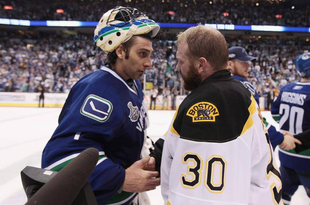 Vancouver Canucks goalie Roberto Luongo congratulates Boston Bruins counterpart Tim Thomas following the Bruins 4-0 in game 7 of NHL Stanley Cup Final hockey at Rogers Arena in Vancouver, Wednesday, June 15, 2011. The Toronto Maple Leafs and Edmonton Oilers were eliminated in the second round of this year’s playoffs to stretch Canada’s title drought to a head-scratching 30 years. THE CANADIAN PRESS/Jonathan Hayward