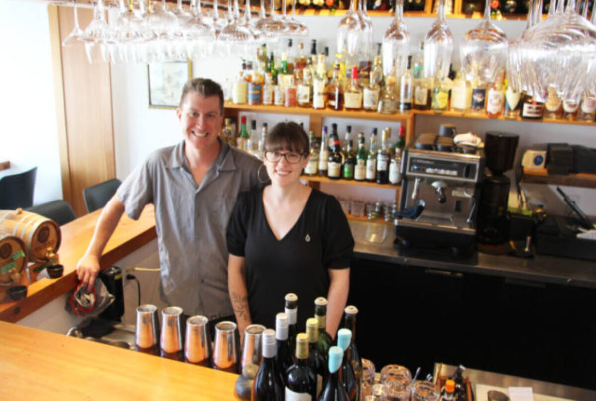 Warren Barr and Lily Verney-Downey smile at the bar of their Pluvio Restaurant. (Westerly file photo)