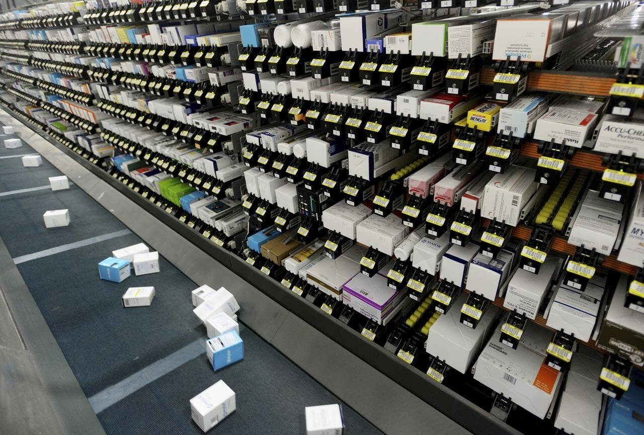 An automatic system drops pharmaceutical orders on a conveyor belt to be placed into boxes at Morris and Dickson Co., in Shreveport, Wednesday, July 13, 2016. The U.S. Drug Enforcement Administration has allowed one of the nation’s largest wholesale drug distributors to keep shipping opioid painkillers for nearly four years after a judge recommended in 2018 it lose its license for its “cavalier disregard” of thousands of suspicious orders fueling the opioid crisis. (Henrietta Wildsmith/The Shreveport Times via AP)