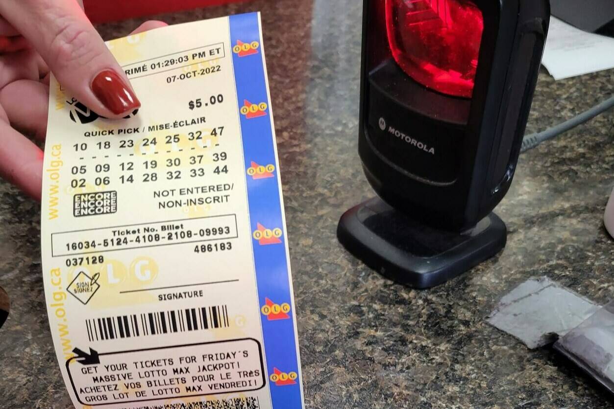 Canada’s largest lottery jackpot can become the largest unclaimed ticket in the country’s lottery history if a winner or a group of winners don’t step forward to grab their prize by next month. A clerk hands a customer their Lotto Max ticket at a gas station north of Newcastle, Ontario on Thursday Oct. 6, 2022. THE CANADIAN PRESS/Doug Ives