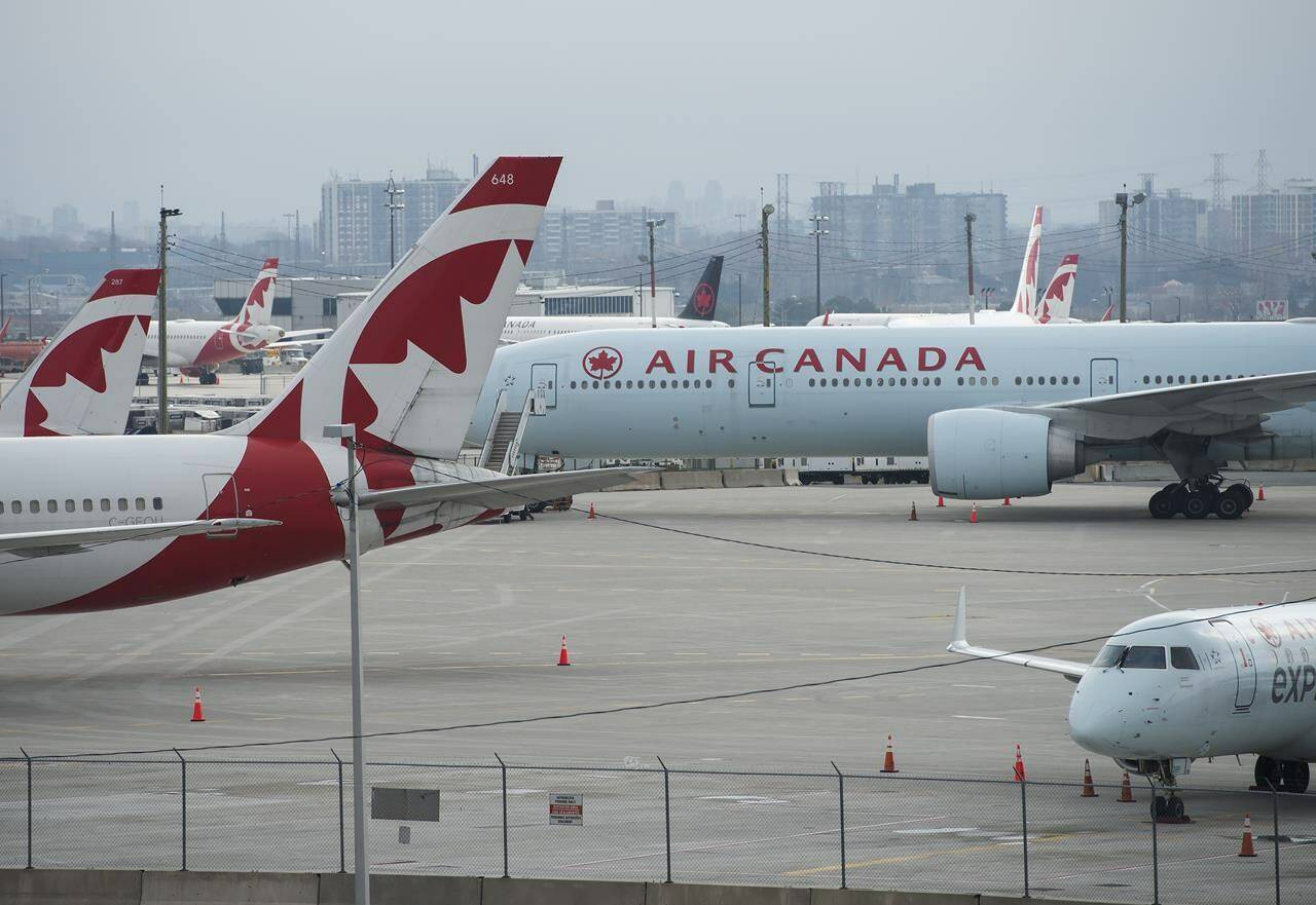 Air Canada planes sit on the tarmac at Pearson International Airport in Toronto on Wednesday, April 8, 2020. THE CANADIAN PRESS/Nathan Denette