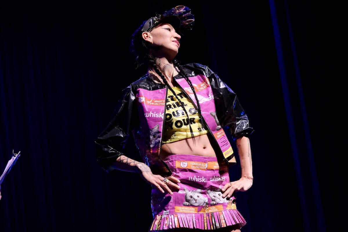 Trashy Cat Lady, designed by Teka Rae Sparkes. Eight pairs of sunglasses, cat food bags, shopping bags, black and white poly, tape, hot glue, old headlamp band, a plastic plant pot and a zipper. Model: Teka Rae Sparkes. Photo: Bill Metcalfe