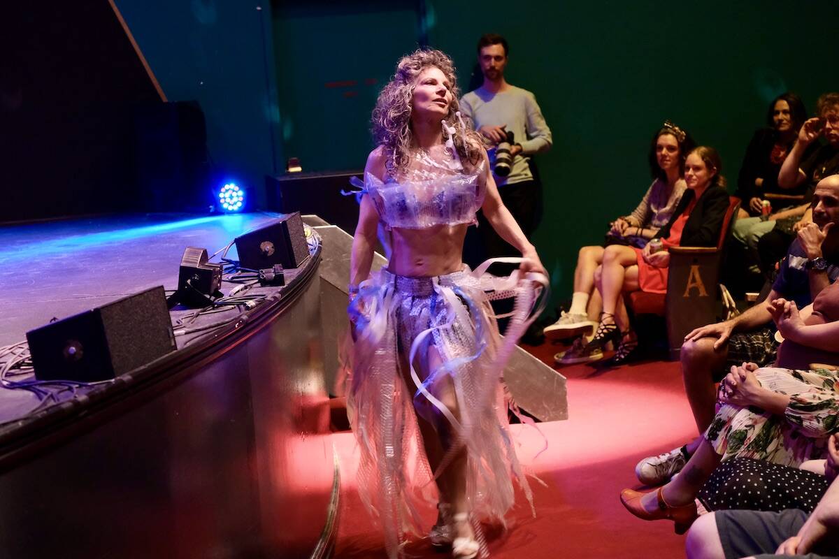 Bubble Wrap Piece, designed by Riya Garg. Inspired by the overwhelming amount of packaging from online shopping, an elegant outfit from bubble wrap, hole punch cut outs and produce mesh bags. Model: Patricia Hogg. Photo: Bill Metcalfe