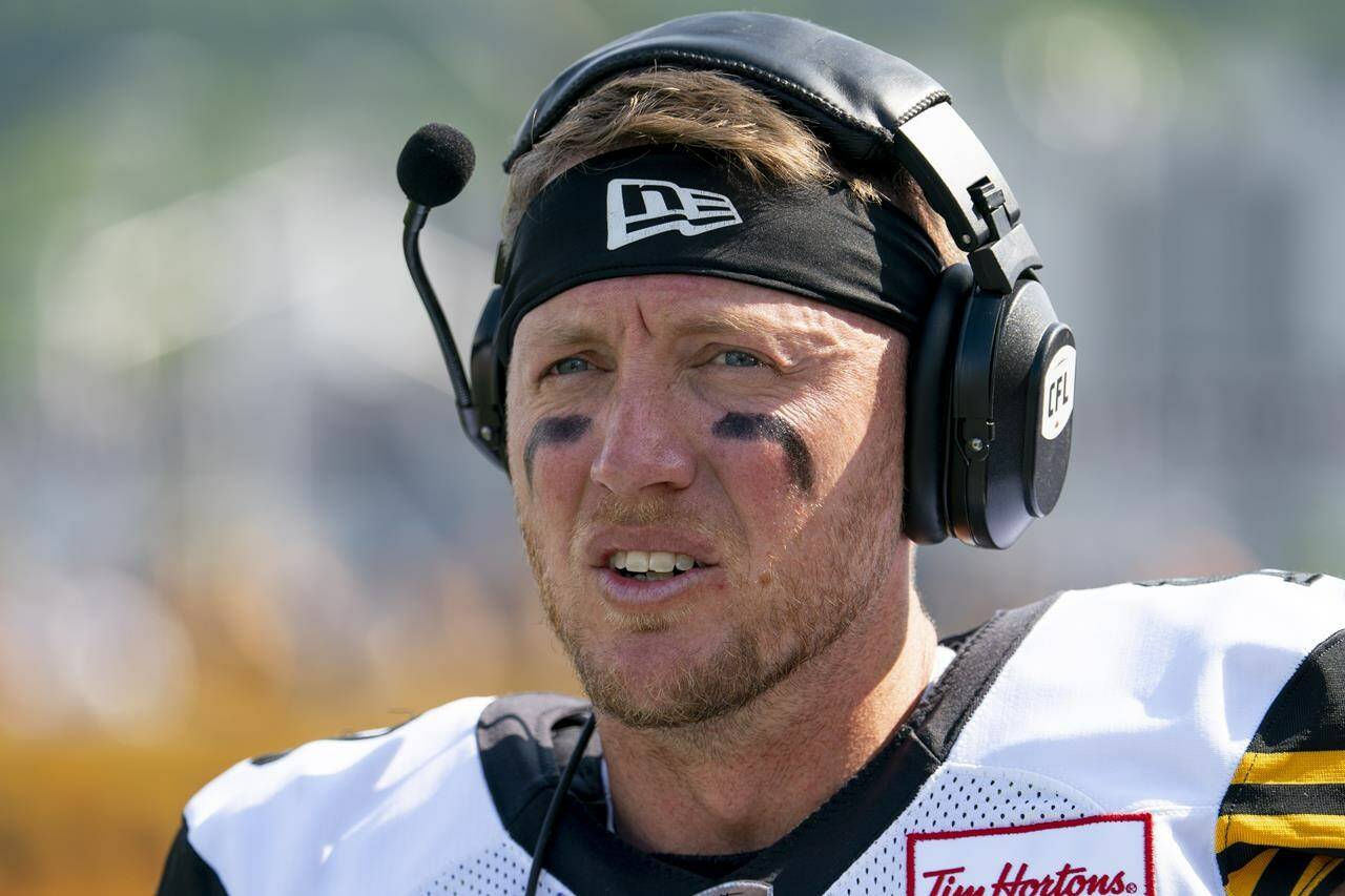 Hamilton Tiger-Cats quarterback Bo Levi Mitchell (19) looks on from the sidelines against the Toronto Argonauts during first half CFL pre-season football action in Hamilton on Saturday, May 27, 2023. Mitchell tops the changing quarterback landscape in the CFL this season.The veteran quarterback enters his ninth season as a league starter but first with Hamilton.THE CANADIAN PRESS/Peter Power