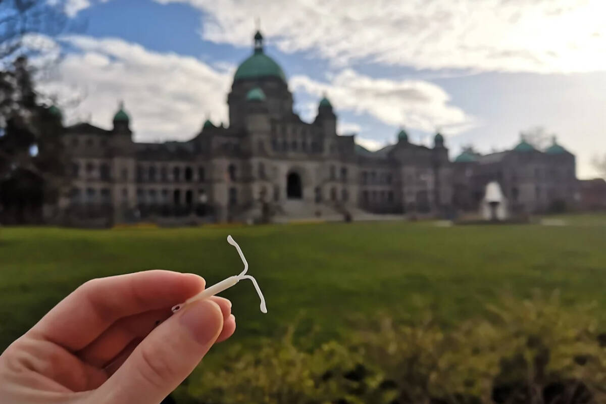 A person holds up an intrauterine device, IUD, outside of the B.C. legislature. B.C. made several types of contraception free to residents with Medical Services Plans April 1, and healthcare workers are seeing an increase in requests for IUDs or information about them. (AccessBC)