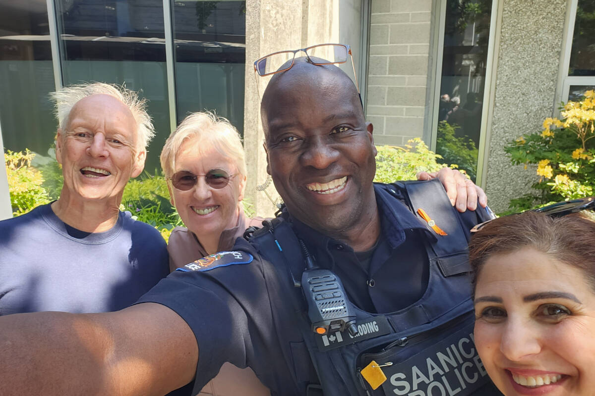 Saanich police Const. Alex Omoding, centre, snags a group selfie with David Batterham, left, Sheila Flood and May Shihadeh after an Islamophobia workshop. (Photo by Alex Omoding)