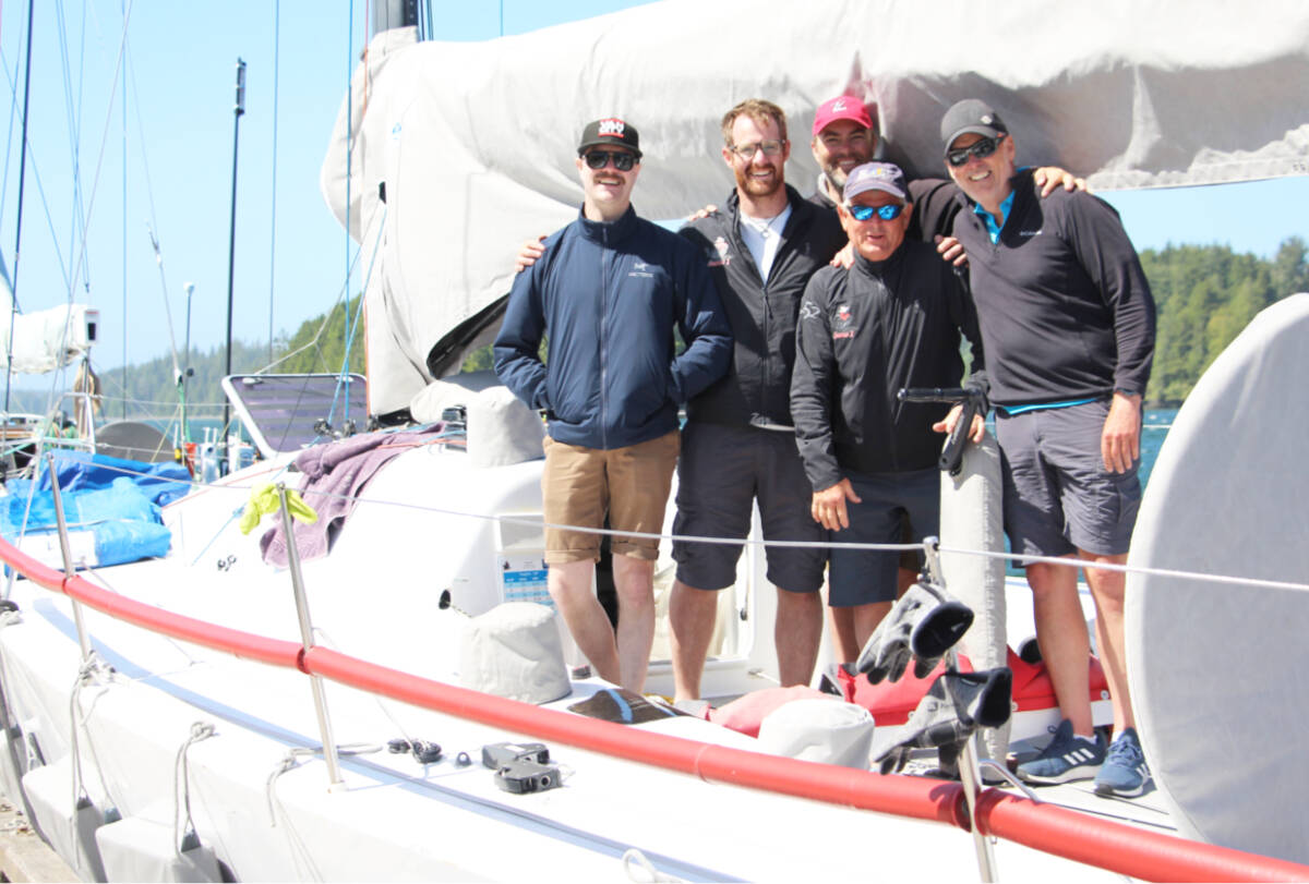 The crew of the Shadow II smile aboard their racing yacht parked at Ucluelet’s 52 Steps on Tuesday, June 13. (Andrew Bailey photo)