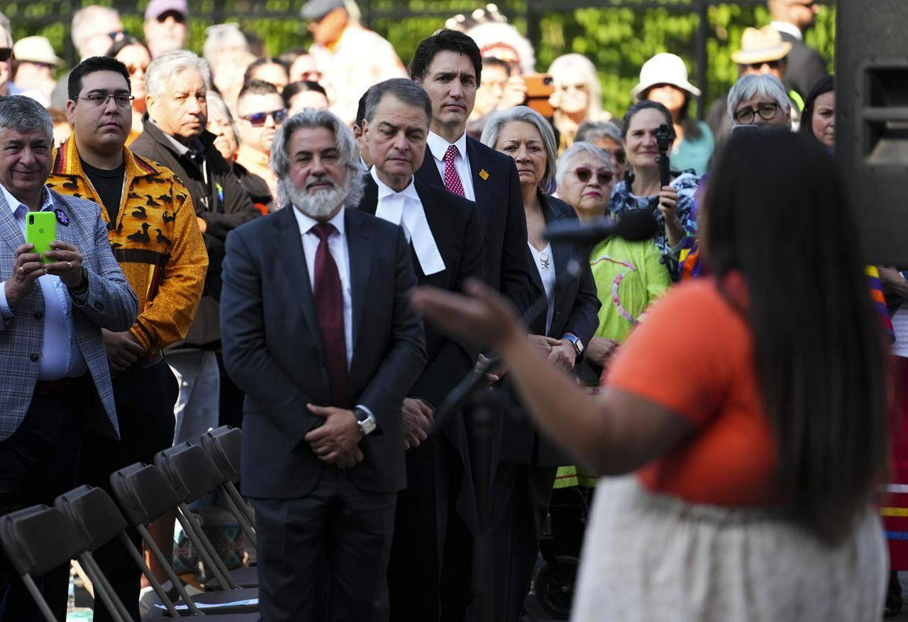 Prime Minister Justin Trudeau and Governor General Mary Simon look on as First Nations Artis Alicia Kayley performs during the site selection ceremony of the Residential Schools National Monument on Parliament Hill in Ottawa on Tuesday, June 20, 2023. THE CANADIAN PRESS/Sean Kilpatrick