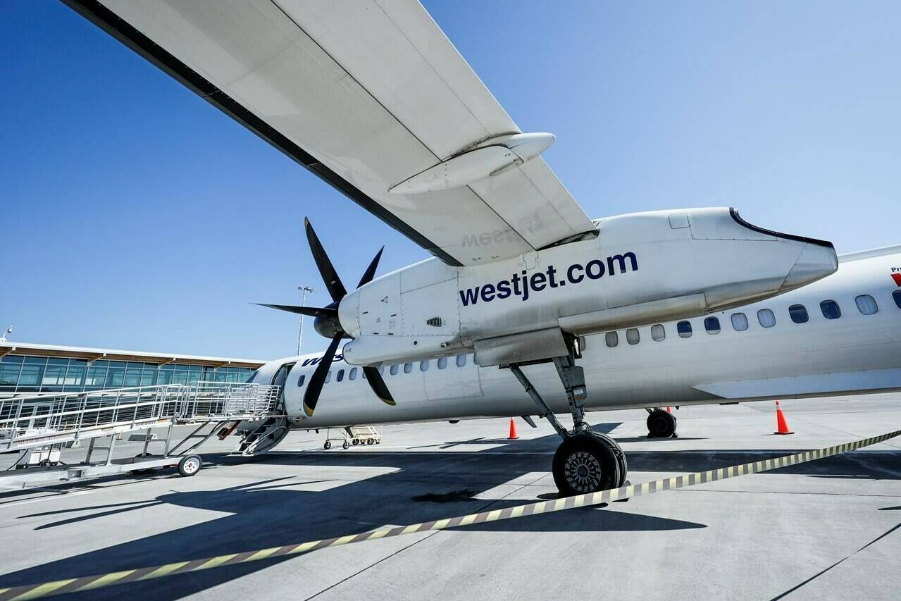 A WestJet Encore Bombardier Q400 twin-engined turboprop aircraft is prepared for a flight in Kamloops, B.C., Saturday, June 3, 2023. WestJet CEO Alexis von Hoensbroech says the integration of discount carriers Swoop and Sunwing Airlines into its mainline operation will tamp down costs and avoid higher fares for customers. THE CANADIAN PRESS/Jeff McIntosh