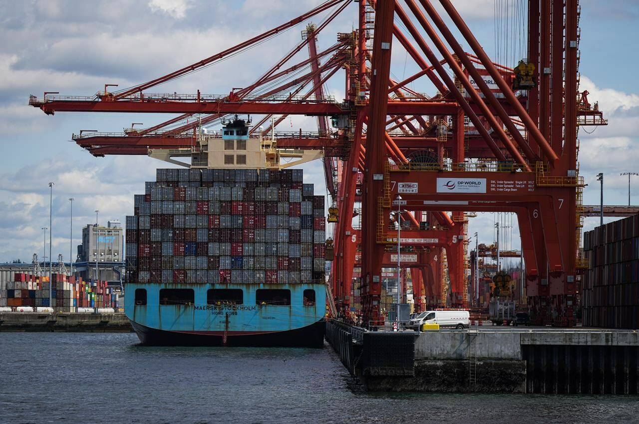 Cargo containers are unloaded from the Maersk Stockholm ship with gantry cranes while docked at port, in Vancouver, on Tuesday, April 25, 2023. The Vancouver Fraser Port Authority says overall cargo volumes fell by three per cent last year, as the global economy began to show signs of a slowdown. Negotiators representing longshore workers and private companies are currently negotiated a new labour deal. (THE CANADIAN PRESS/Darryl Dyck)