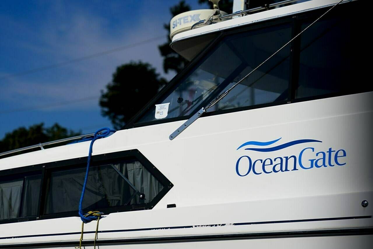 A boat with the OceanGate logo is parked on a lot near the OceanGate offices Thursday, June 22, 2023, in Everett, Wash. The U.S. Coast Guard said Thursday that the missing submersible Titan imploded near the Titanic shipwreck site, killing everyone on board. (AP Photo/Lindsey Wasson)