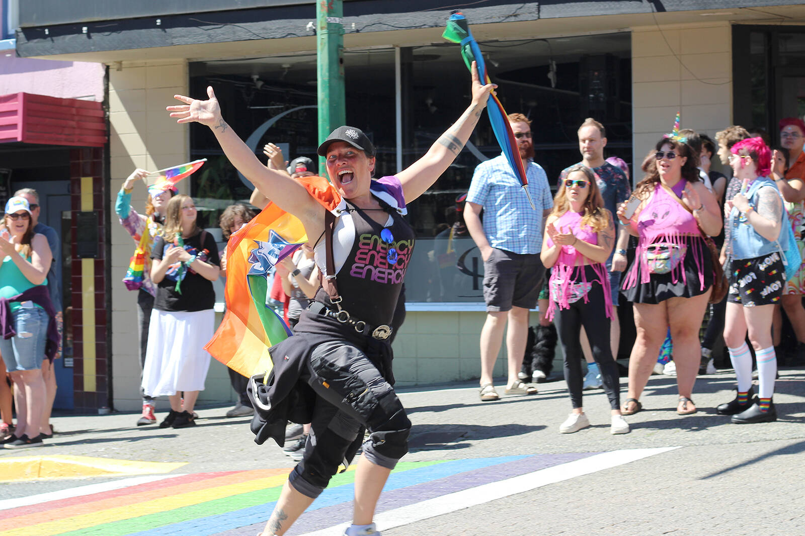 Mia Johnson, representing the International Alliance of Theatrical Stage Employees, takes the parade route at a run during Nanaimo’s Pride parade Sunday, June 11. (Greg Sakaki/News Bulletin)