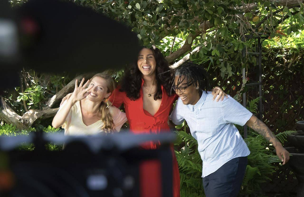 This image released by Focus Features shows Alicia Roth Weigel, from left, River Gallo and Sean Saifa Wall during the filming of the documentary “Every Body.” (Focus Features via AP)