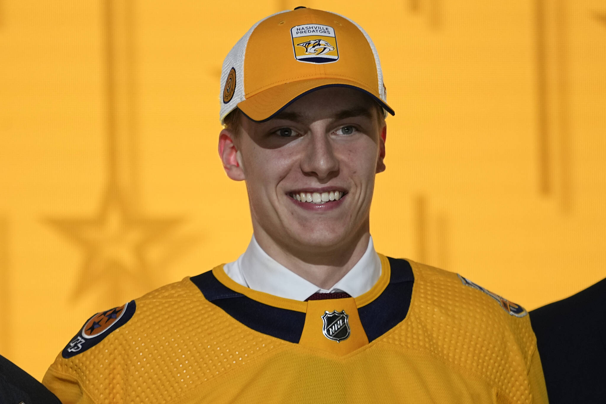 Nanaimo’s Matthew Wood wears a Nashville Predators hat and jersey after being picked by the team during the first round of the NHL hockey draft Wednesday, June 28, 2023, in Nashville, Tenn. (AP Photo/George Walker IV)