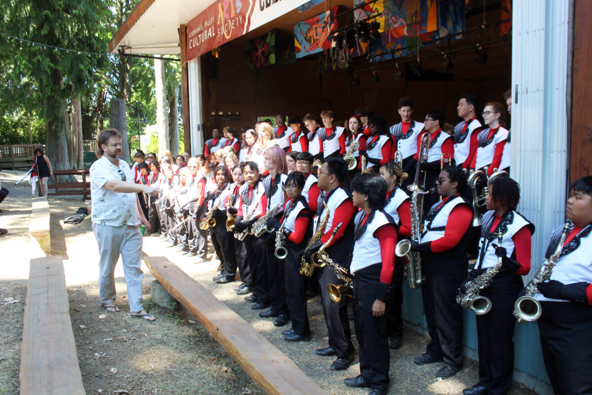 Vince Strem lines up the Our Lady Of the Rockies marching band at the Waterwheel Park Bandshell. (Photo by Don Bodger)