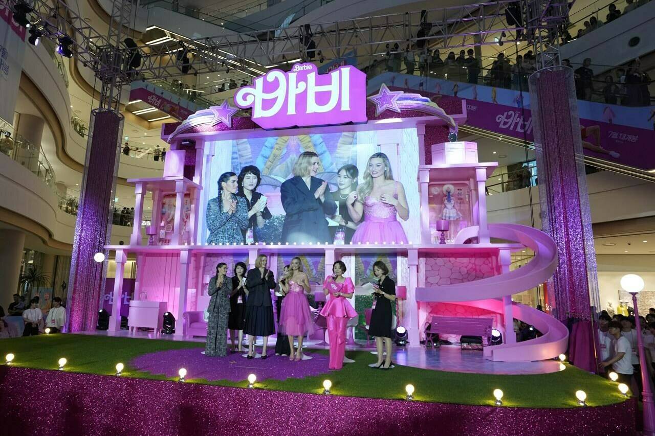 A screen shows America Ferrera, left, director Greta Gerwig, center, and Margot Robbie, right, during the pink carpet event for the movie “Barbie” in Seoul, South Korea, Sunday, July 2, 2023. Vietnam’s state media have reported that the government banned distribution of the popular ‘Barbie’ movie because it includes a view of a map showing disputed Chinese territorial claims in the South China Sea. (AP Photo/Ahn Young-joon)